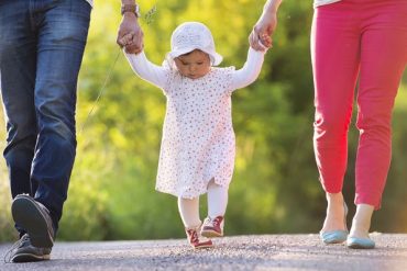 child and parents walking together